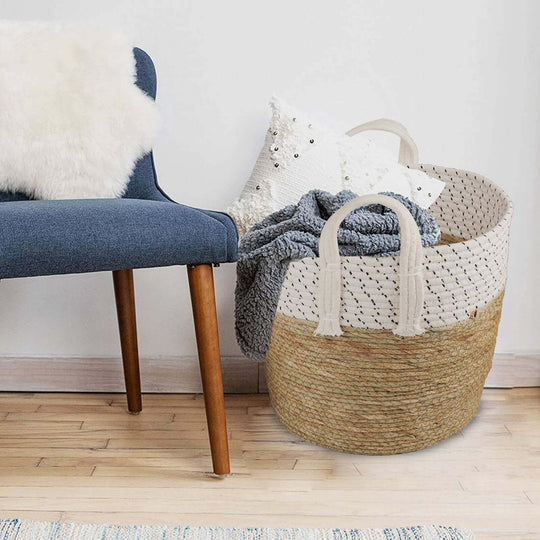 Affordable handmade cotton rope storage basket set with carry handles, stylishly placed beside a comfy chair.