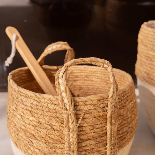 Handwoven cotton rope storage baskets with carry handles and wooden utensil, ideal for affordable home organization.