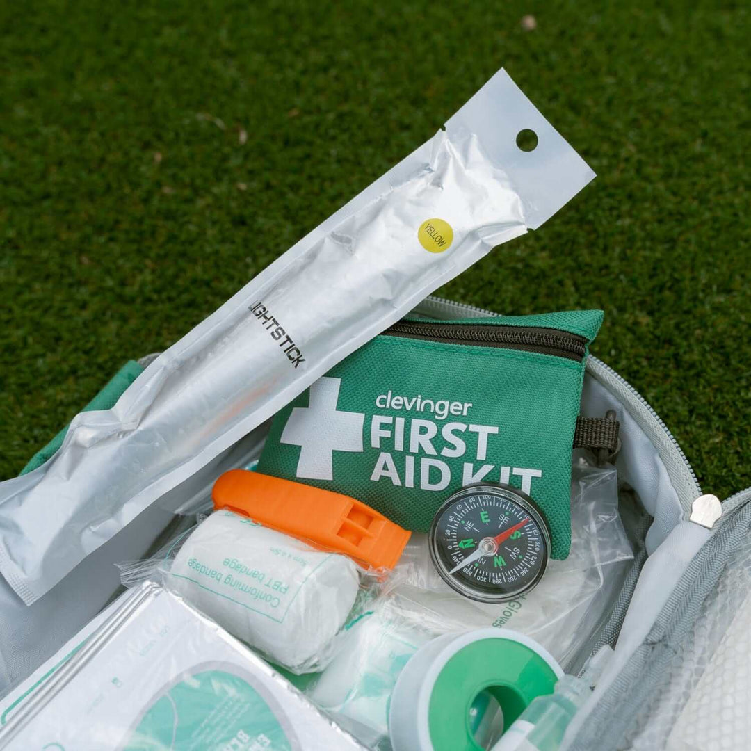 Clevinger 258 Piece Premium 2-in-1 Emergency First Aid Kit displayed with essential tools in a green bag.