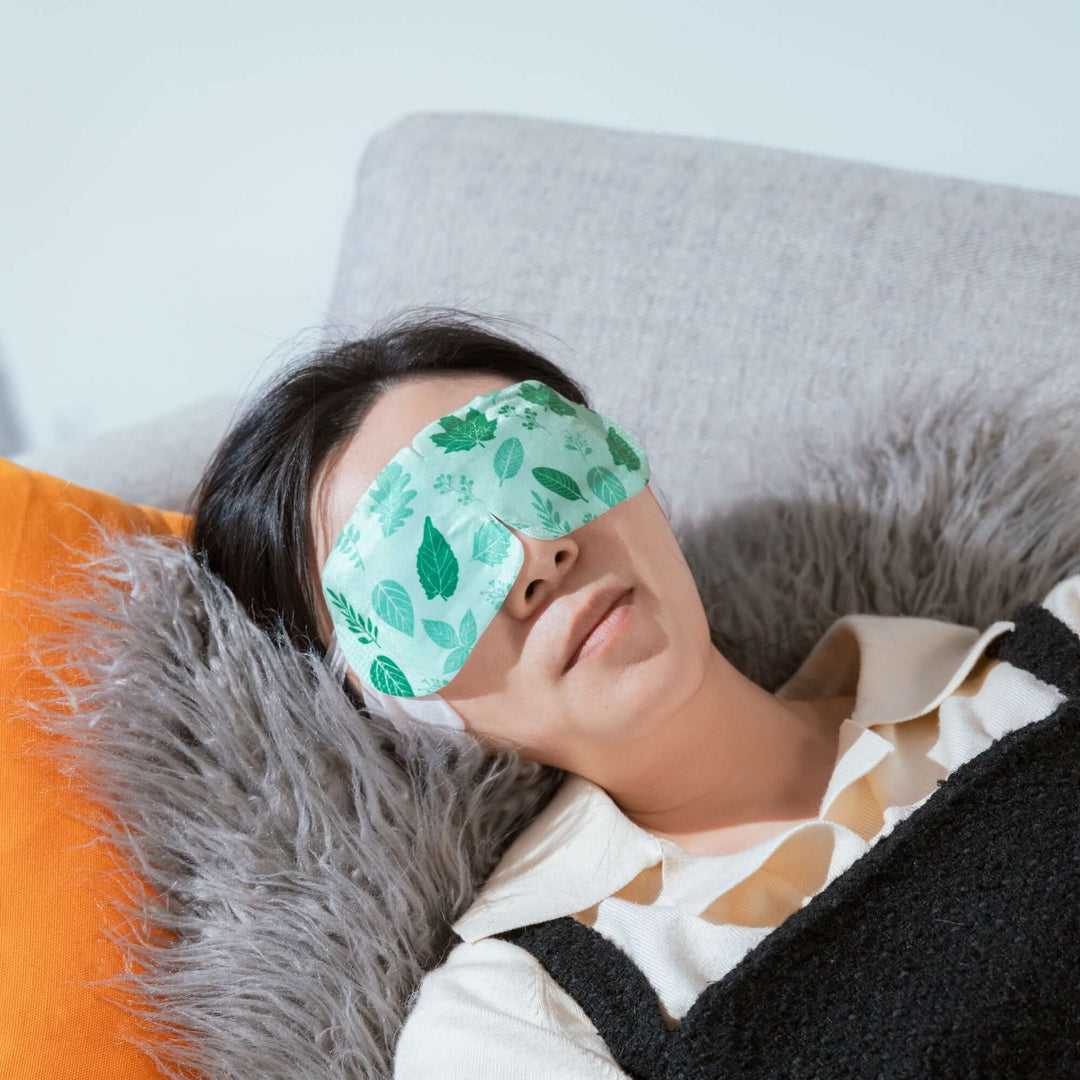 Woman relaxing with a soothing eye mask, enjoying an instant spa experience, ideal for eyestrain relief.