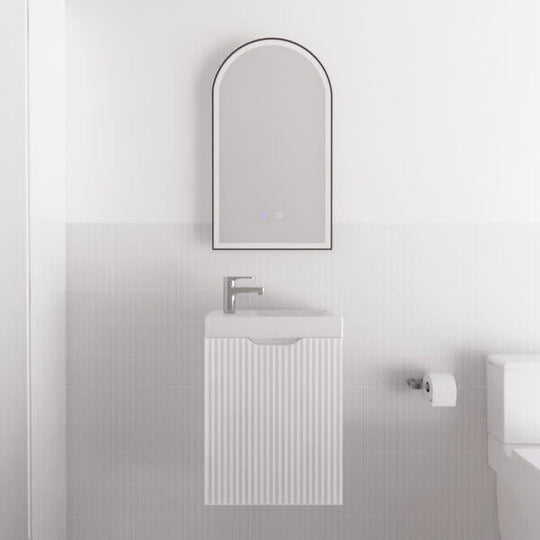 Affordable Vienna Matt White wall hung mini vanity with fluted style door and rounded mirror, perfect for DIY Luxe bathrooms.