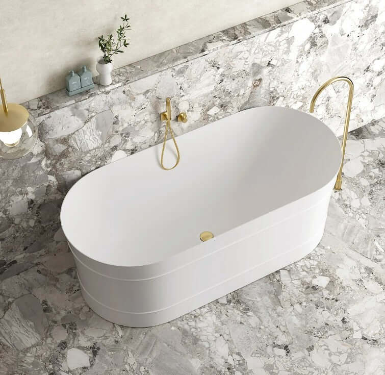 Elegant freestanding oval bathtub in gloss white on marble floor, ideal for luxurious DIY bathrooms.