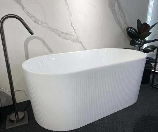 Affordable oval freestanding bathtub in gloss white, featuring ribbed design, perfect for DIY luxury bathrooms.