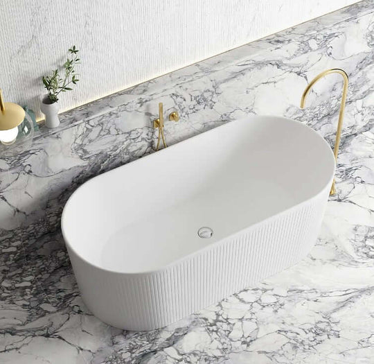 Affordable oval freestanding bathtub in glossy white on marble surface, perfect for DIY luxury bathroom designs.