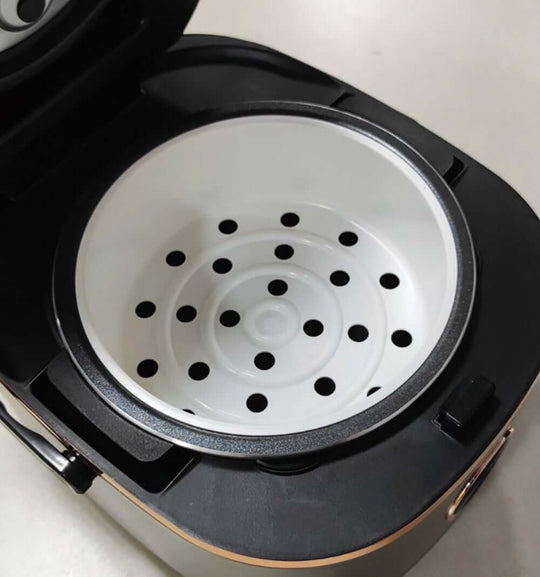 Interior view of Joyoung Mini Rice Cooker 2L showing removable inner pot with steam holes for easy cooking.