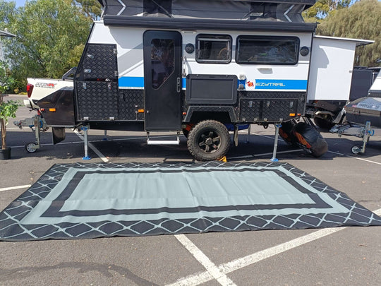 Spacious 5m x 2.4m recycled camping mat set up outside a campervan, perfect for outdoor adventures and sustainability.