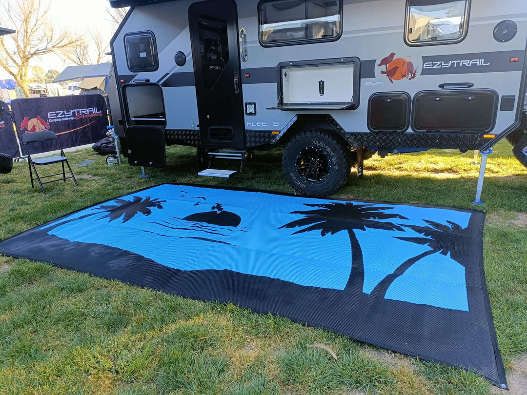 Spacious 5m x 2.4m recycled poly camping mat with palm tree design under an EZYtrail camper. Affordable outdoor comfort.