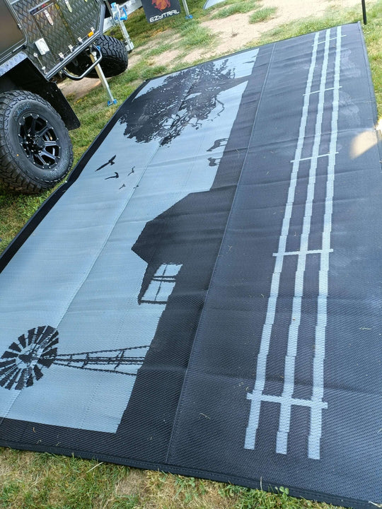 Country Grey recycled poly mat on grass, featuring a windmill and rustic farmhouse design for camping.