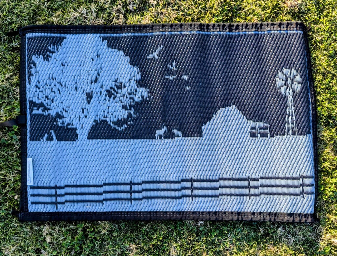 Country Grey recycled poly mat with scenic farm design, ideal for camping and outdoor adventures.