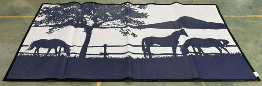 Large outdoor mat featuring horses and a tree silhouette against a scenic backdrop, ideal for camping or picnics.