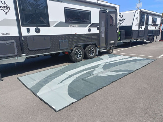 Spacious Swish Grey 5m x 2.4m recycled poly mat laid out beside a dual-axle camping van. Ideal for outdoor adventures.