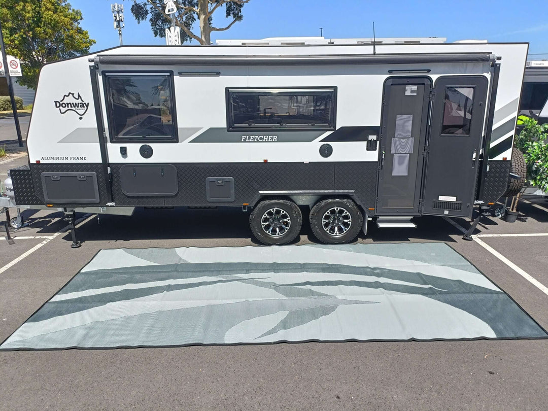 Grey 5m x 2.4m recycled poly mat under a modern camper van, showcasing quality and durable outdoor comfort.