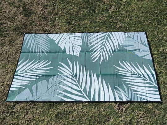 Tropical 6m x 2.4m recycled poly mat featuring leafy design, ideal for camping and outdoor use. Affordable quality and luxe comfort.