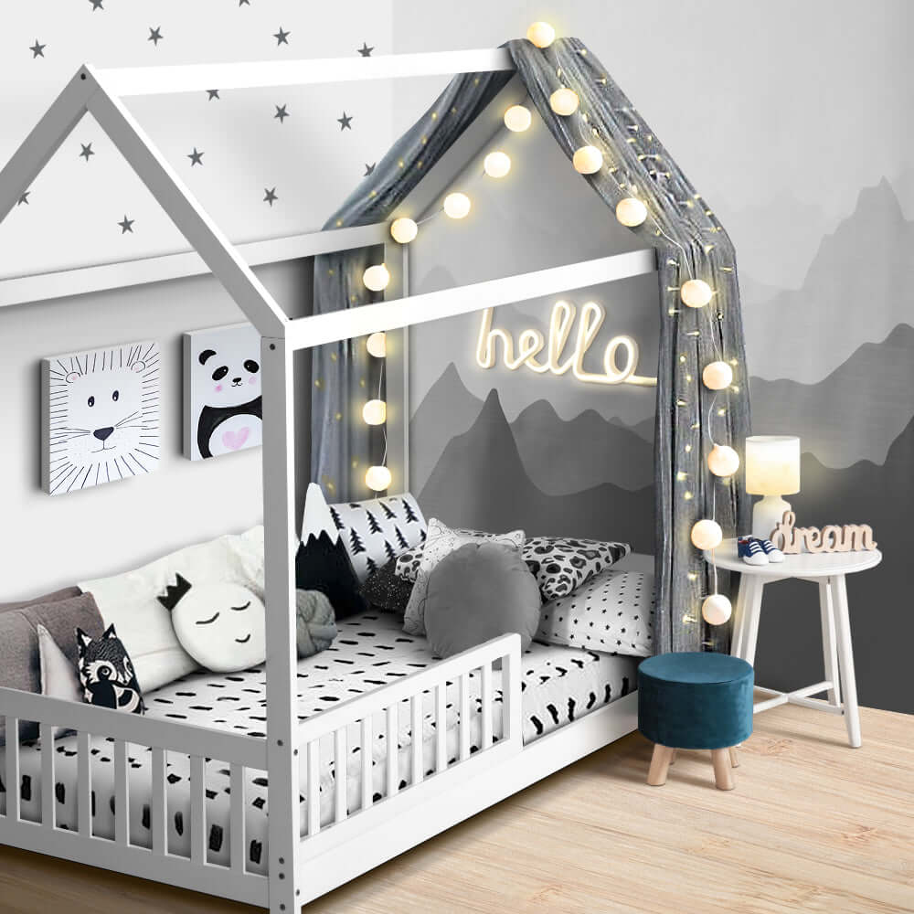 Stylish wooden kids bed frame in white with decorative lights and cozy cushions, perfect for a child's room.