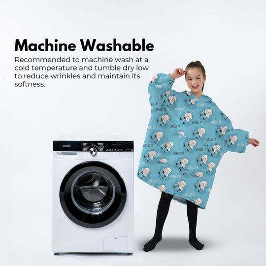 Child wearing GOMINIMO Hoodie Blanket in light blue with sheep print, next to a washing machine. Machine washable for easy care.