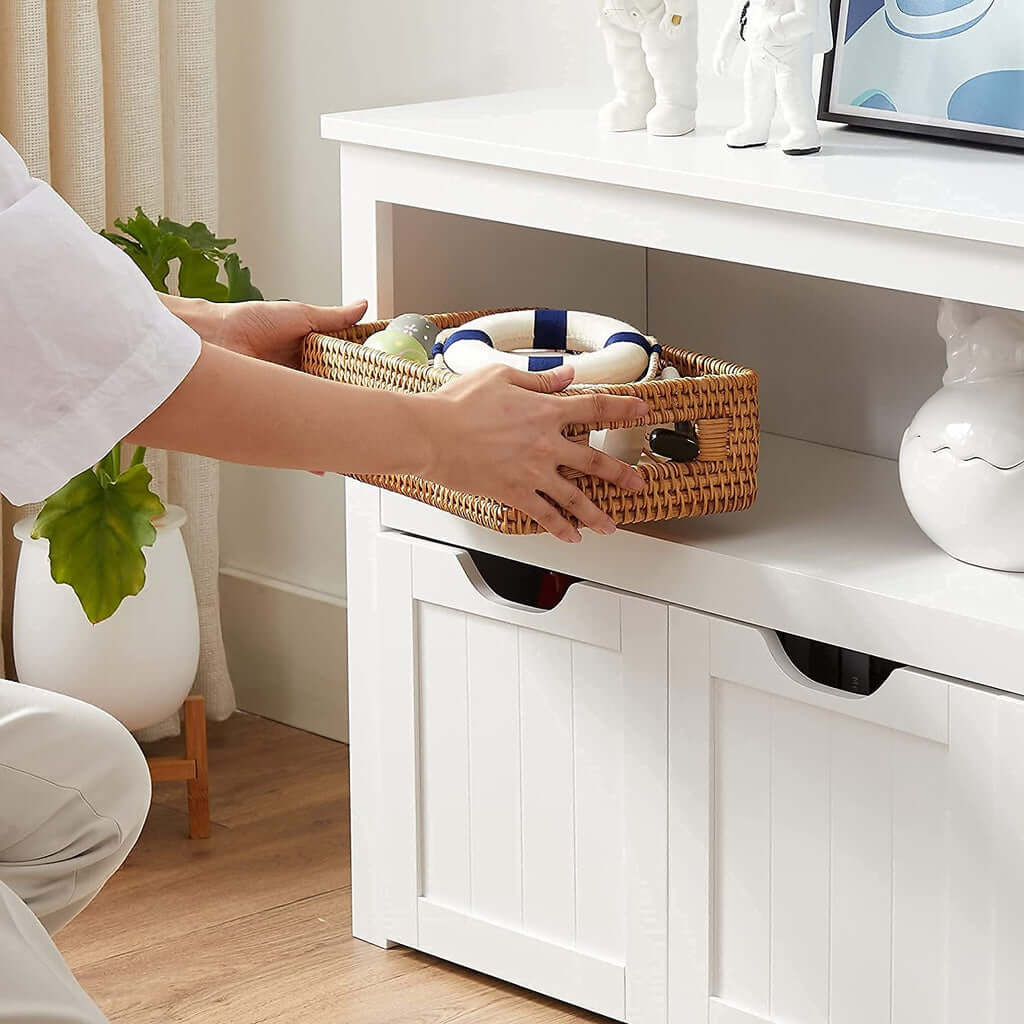 Person organizing basket in VASAGLE affordable luxe storage bench with shelf and drawers in a stylish room setting.