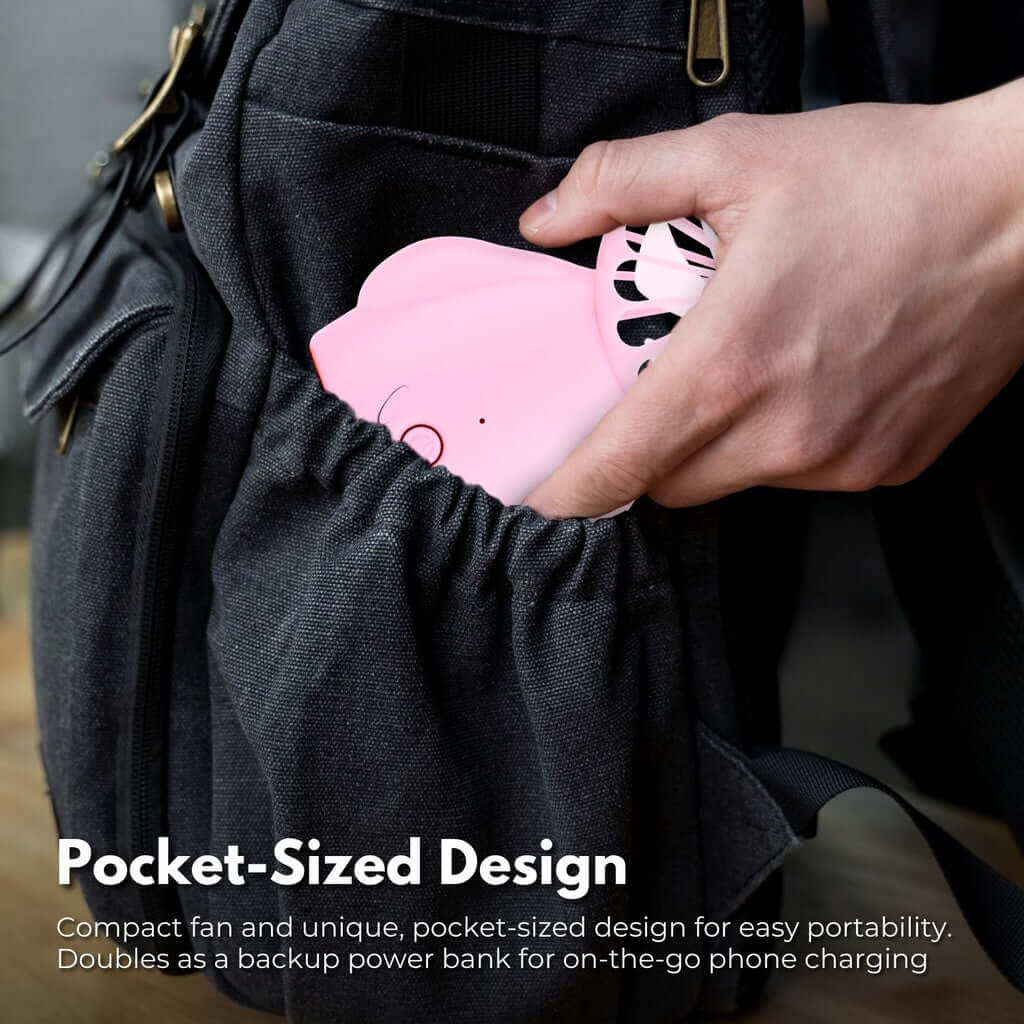 Person placing a compact pink Gominimo handheld fan into a bag, highlighting its pocket-sized portability.