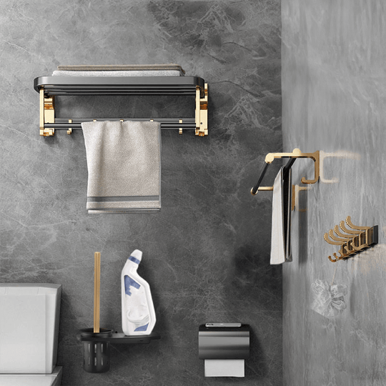 Stylish black gold bathroom accessories set on wall; includes towel holder and hooks, perfect for luxe and affordable DIY décor.