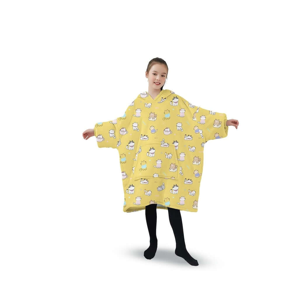 Girl wearing GOMINIMO Kids Cat yellow hoodie blanket with comfy flannel and Sherpa fleece, featuring playful cat designs.