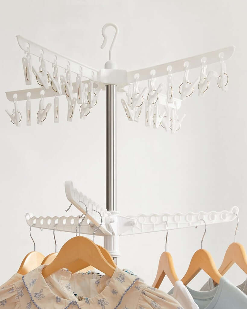 SONGMICS 2-Tier Clothes Drying Rack with rotatable arms, 24 clips, hanging clothes, and sleek white and silver design.