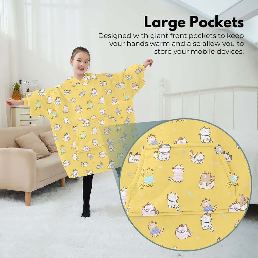 Girl wearing GOMINIMO kids cat hoodie blanket with large pockets for warmth and storage, featuring a cozy yellow design.