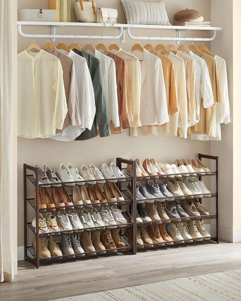 Bronze SONGMICS 8-tier shoe rack holding various shoes, beneath a row of hanging clothes in a tidy closet space.