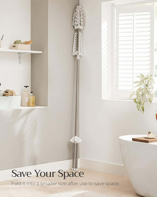 Foldable drying rack in a minimalistic bathroom, showcasing space-saving design and sleek style.