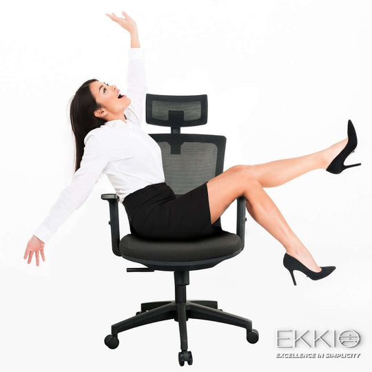 Woman happily sitting on EKKIO Zorae ergonomic office chair in black, showcasing comfort and style in a professional setting.