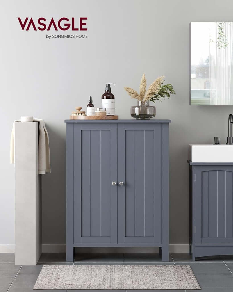 VASAGLE floor cabinet with 2 doors in gray, featuring adjustable shelves and chromed knobs, positioned in a modern bathroom setting.