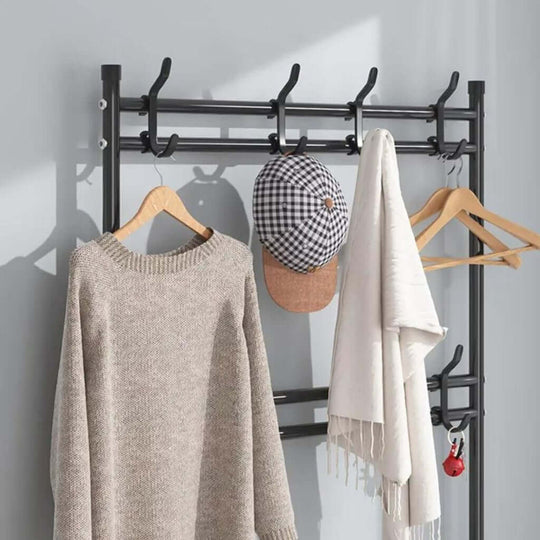 Black clothes rack with shelf, featuring hooks holding a sweater, hat, and scarf, showcasing affordable and quality DIY home storage.