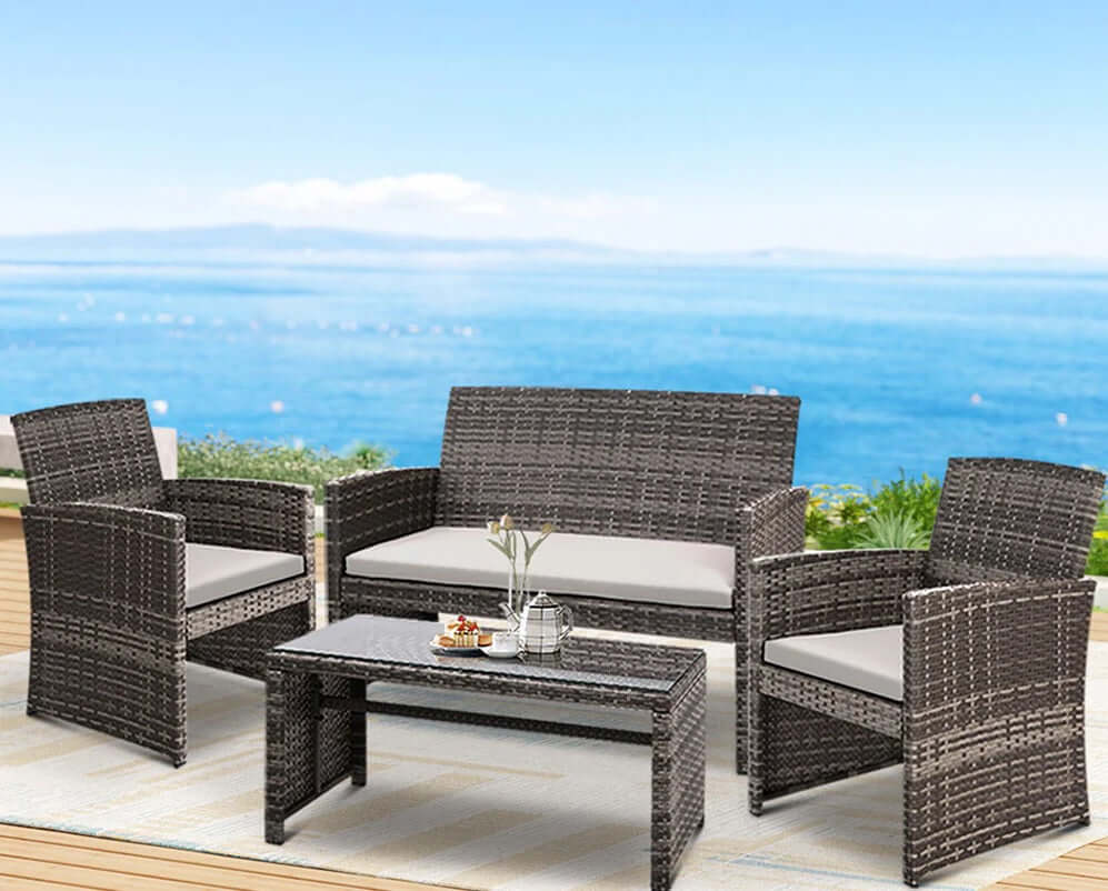 Affordable DIY luxury patio furniture set with quality wicker chairs and table by the ocean.